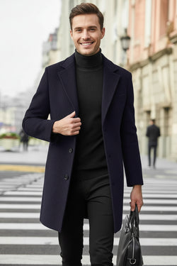 Man wearing a dark coat and black outfit crossing a street.